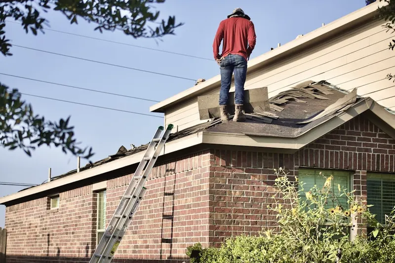 Professional roofer working on a residential roof in Monmouth Beach